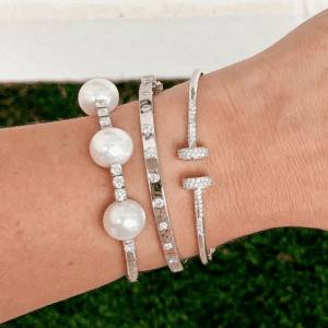 pearl, diamond, and silver bracelets on model