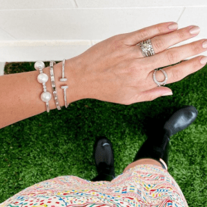 silver and diamond bracelets and rings on model