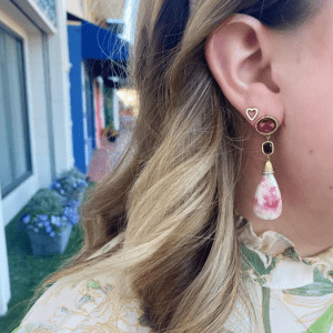pink stone earring and gold heart earring on model