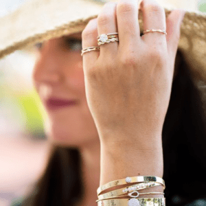 gold and diamond bracelets and rings on model