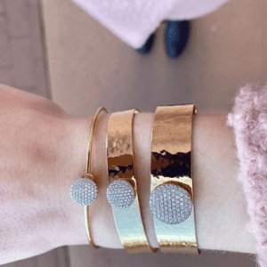 three gold and diamond bracelets on model