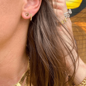 2 gold earrings on model with gold necklaces, rings and bracelets