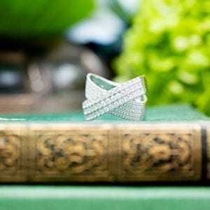 pave diamond ring on green and gold book
