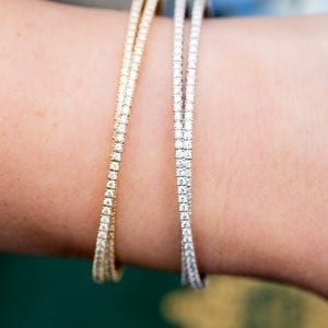 closeup view of pave diamond flexable crossover cuff bracelets on woman's wrist