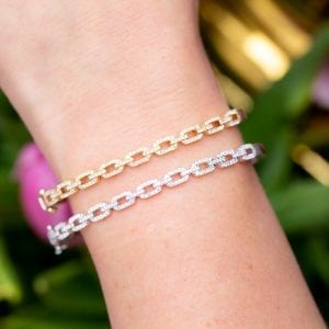close up view of woman's wrist wearing two pave diamond link bracelets