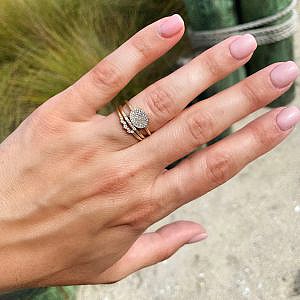 gold and diamond rings on womens hand