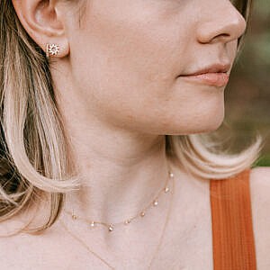 woman wearing earrings and necklaces