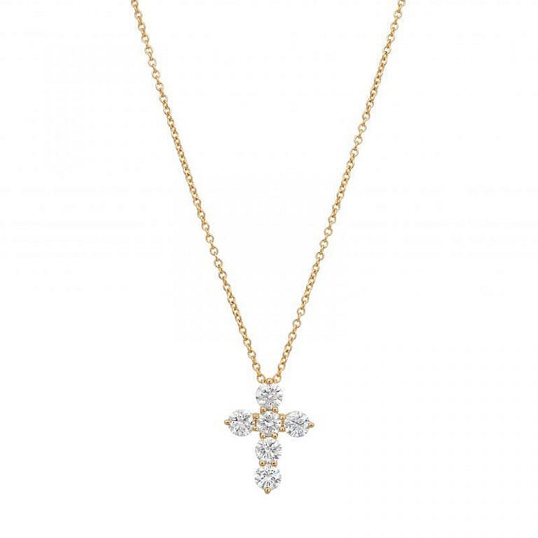 yellow gold diamond cross necklace on white background