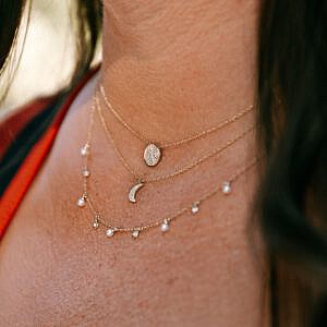 neck with three diamond necklaces