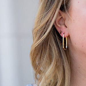 elongated oval hoops in yellow gold on model