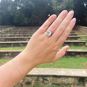 engagement ring on womens hand with diamond by yard bracelet