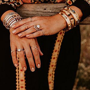 Hands touching wearing diamonds.