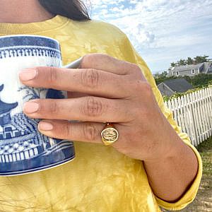 signet ring with cursive monogram engraving on pinky finger