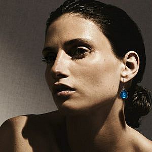 model wearing silver drop earrings