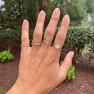 gold and diamond collection rings on women's hand