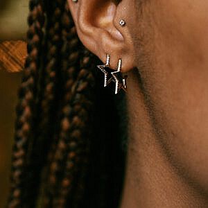 open star diamond hoop earrings on ear