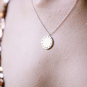 White gold and diamond pendant on neck