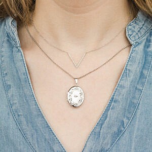 woman wearing sterling silver locket and chevron necklace