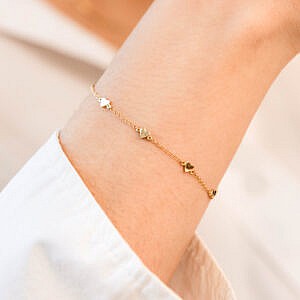 Yellow gold heart bracelet on arm